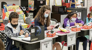 Students in a classroom with COVID safety protocols.