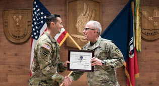 U.S. Army Capt. Christopher Donaghe (L) receives award from Brig. Gen. Mark Thompson