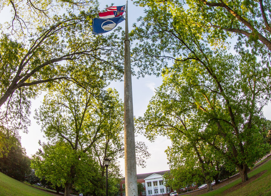 fish lens shot of sweet heart circle's flag pole with the American flag, Georgia flag, and Georgia Southern flag
