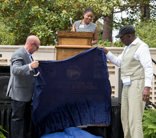 two men pulling a sheet off of the new marker on Statesboro campus