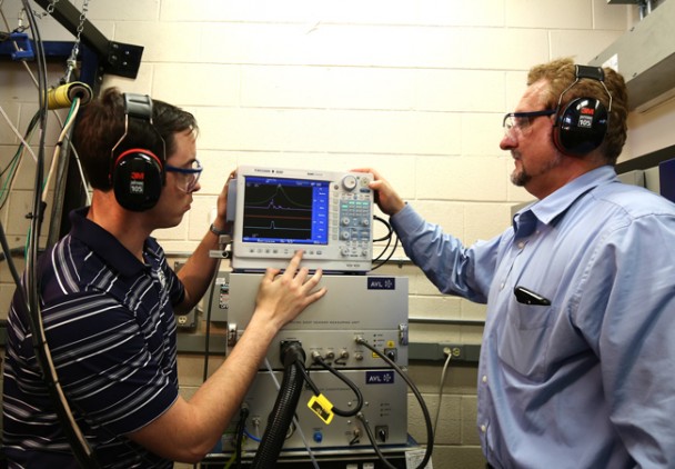 Martin Muinos (left) works with Val Soloiu, Ph.D. (right), on a high speed data acquisition system able to detect minute amounts of soot in engine exhaust -- part of  Muinos' Reactivity Controlled Compression Ignition research project for the National Science Foundation. 