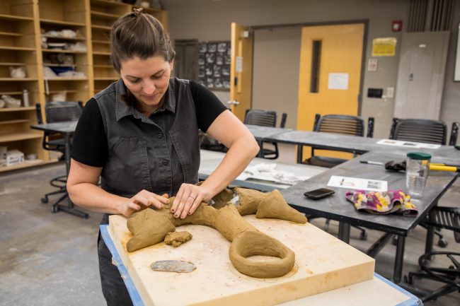 Casey Schachner (above) forms a sculpture made of algae for an exhibit at the UGA Marine Education Center. “SUBMERGED: An Underwater Exhibition of Bioceramic Artwork" will be open on June 10.