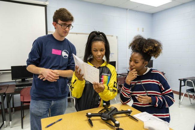 Wayne Johnson, Ph.D., examines a drone with mechanical engineering student Lydia Poole. Drones like this one will be used during the 2020 Engineering Design Challenge. 