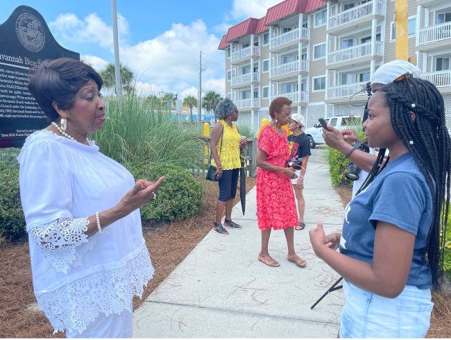 Joyah Mitchell (right) talks to Tybee locals about the history of the island. Mitchell was part of a research team at Georgia Southern University who developed a digital map for history fans.