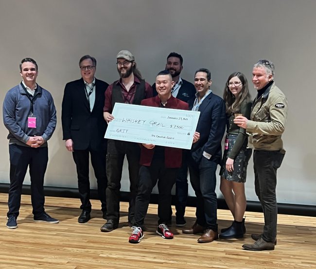 Jim Walker and Adam Tsang, owners of Whiskey Grail, accept a prize check after being named the runner up at the 2023 GRIT Conference Startup Stage Pitch Competition. 